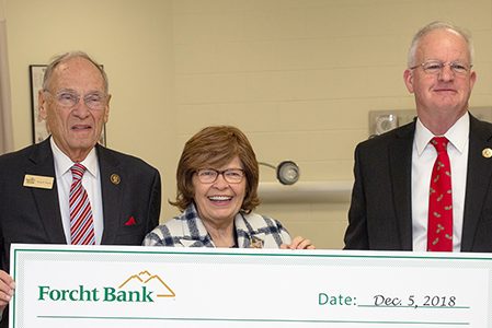 forcht family with president of the university of the cumberlands holding a big check