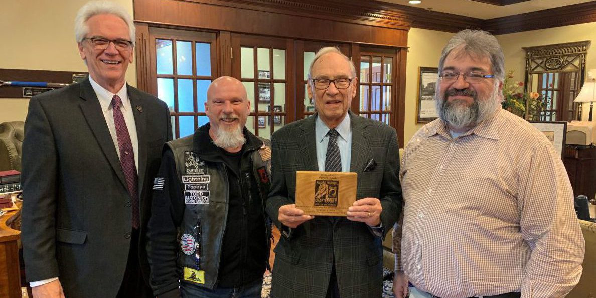 Rolling Thunder: four men smiling at the camera holding a plaque