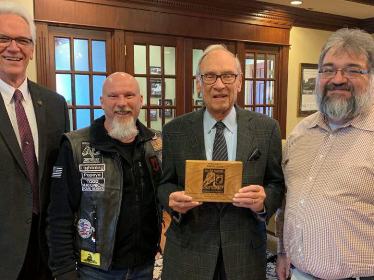 Rolling Thunder: four men smiling at the camera holding a plaque