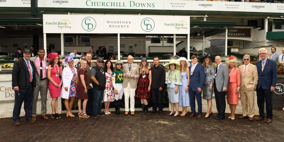 145th Kentucky Derby Forcht Bank: group of people posing for the camera with a jockey