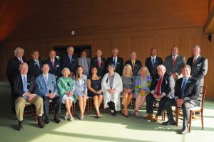 Hall of Fame: group of people sitting and standing smiling at the camear