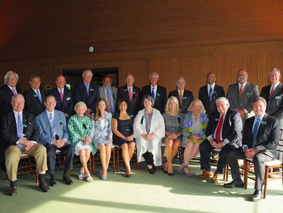 Hall of Fame: group of people sitting and standing smiling at the camear