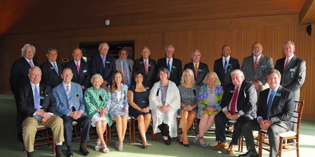 Hall of Fame: group of people sitting and standing smiling at the camear