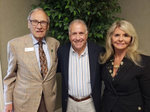 Terry Forcht and Mrs. Debbie with anchor Peter King smiling at the camera