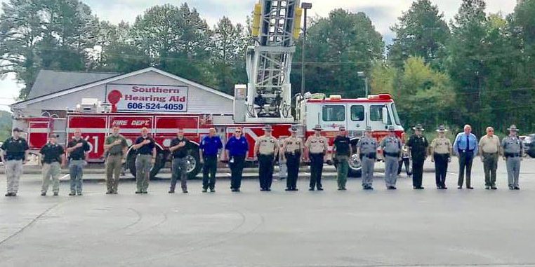 forcht bank Forcht Bank: uniformed officers standing in front of a fire truck saluting