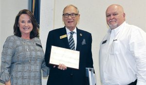 Forcht: two men and a woman smiling at the camera