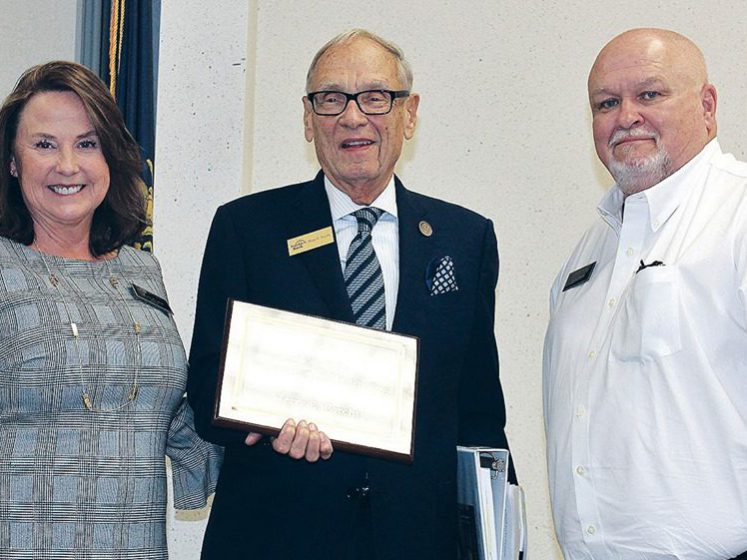 Corbin: two men and a woman smiling at the camera