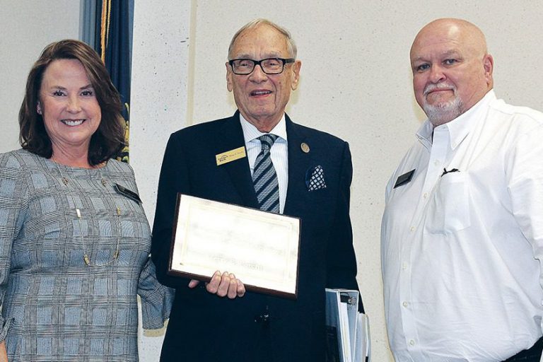 Corbin: two men and a woman smiling at the camera